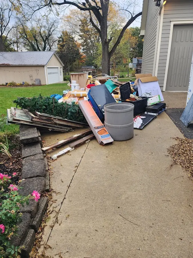 Dumpster being loaded with debris for 12 Yard Dumpster Rental in Hermiston